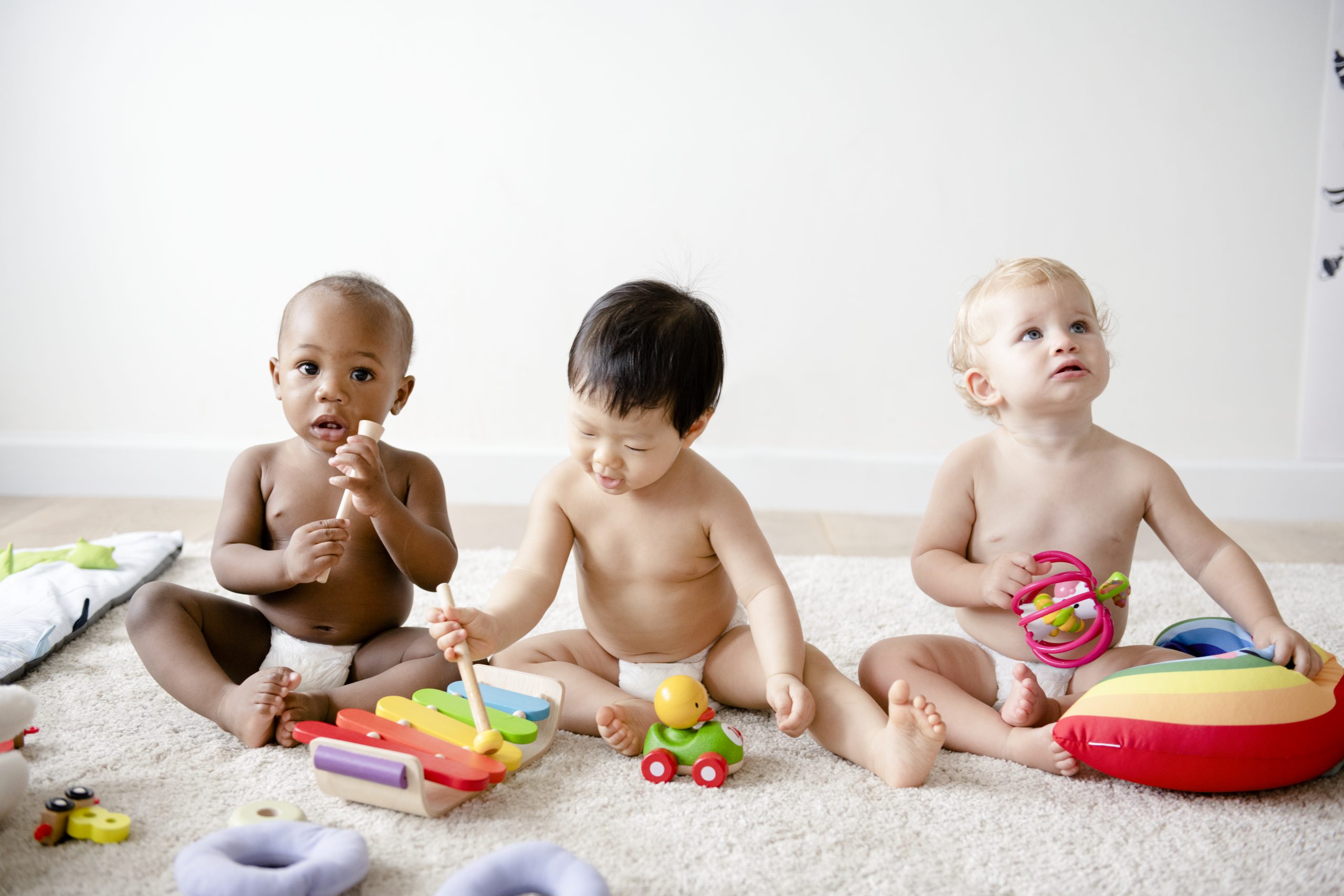 Babies playing together in a play room