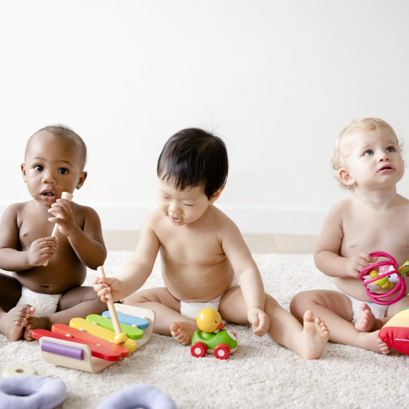 Babies playing together in a play room